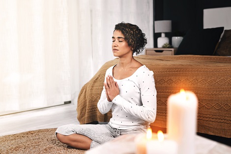 young woman meditating at home