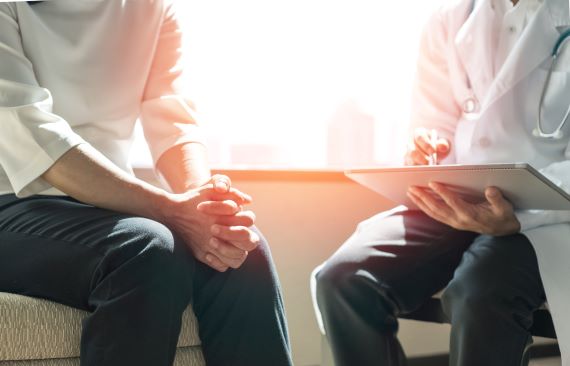 photo of woman sitting with physician at an appointment 