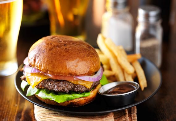 photo of cheeseburger, fries and ketchup on a plate