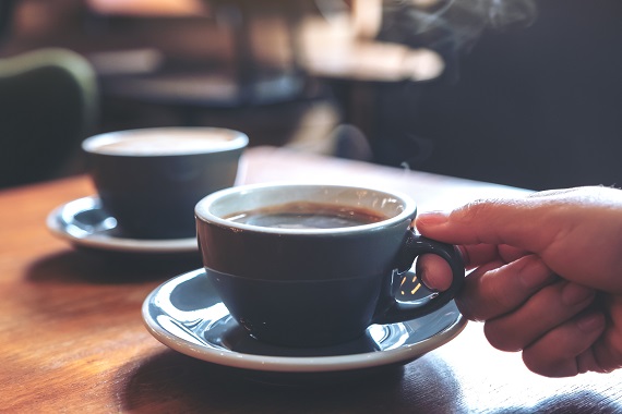 steaming cup of a hot beverage on a saucer