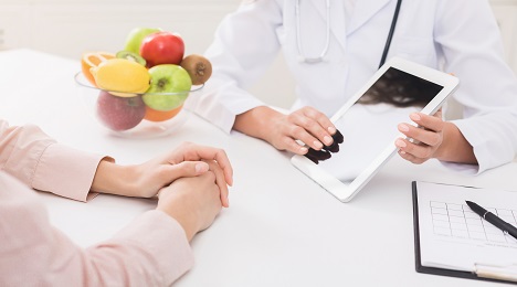 dietitian showing tablet to patient