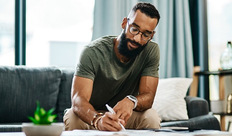 man writing in a journal