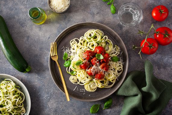 plate filled with zucchini noodles and meatballs