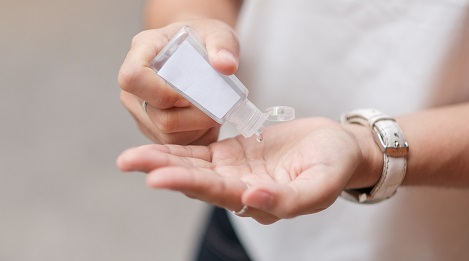 a person applying hand sanitizer