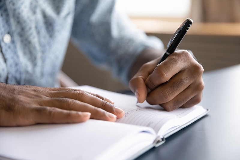 a person writing in a journal