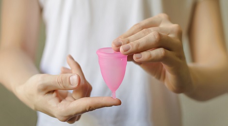 Women holding a Menstrual cup.