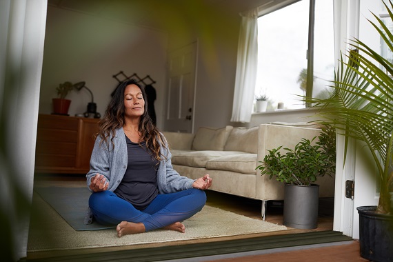 woman meditating in her living room