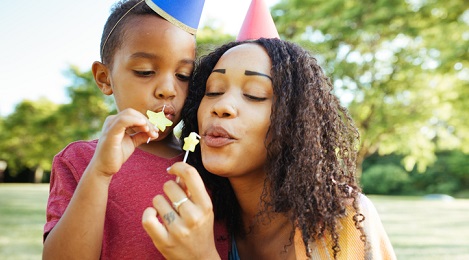 Women celebrating her birthday with her child.