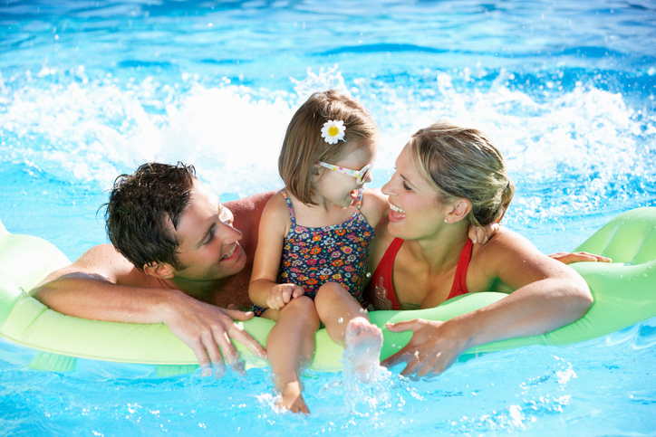 Family swimming in a pool.