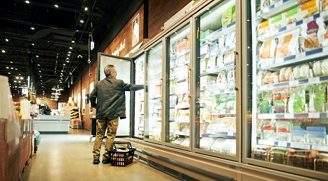 Reading food labels while shopping at the grocery store.