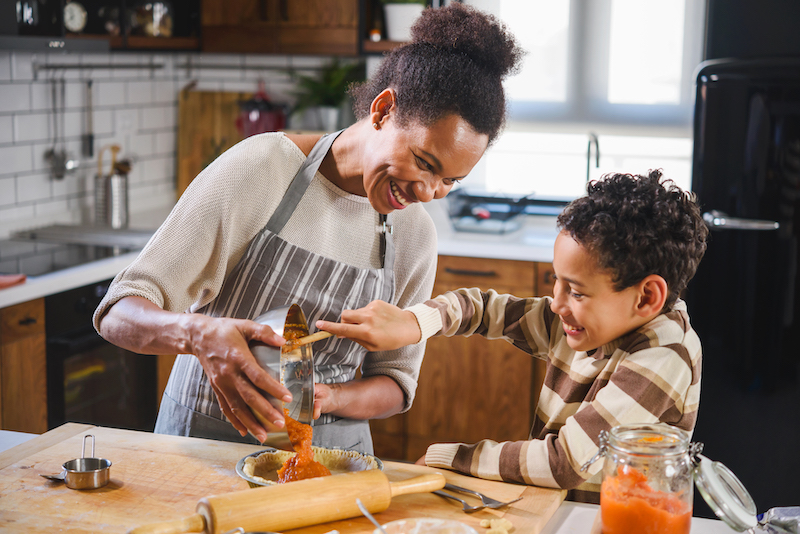 woman baking with child