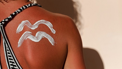 Sunscreen spread on someone's back.