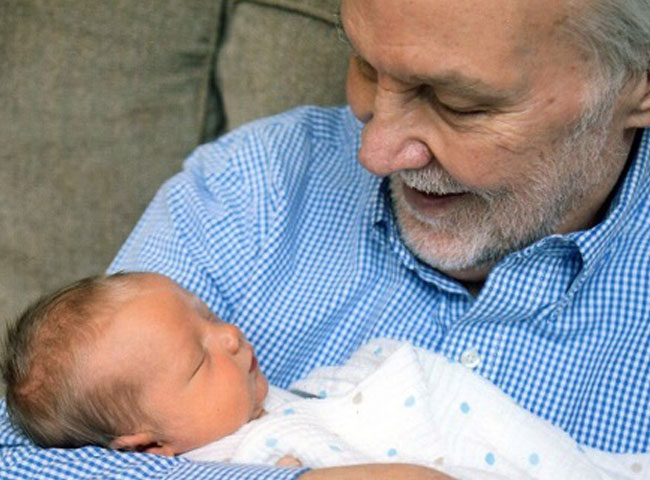 Older man holding a baby