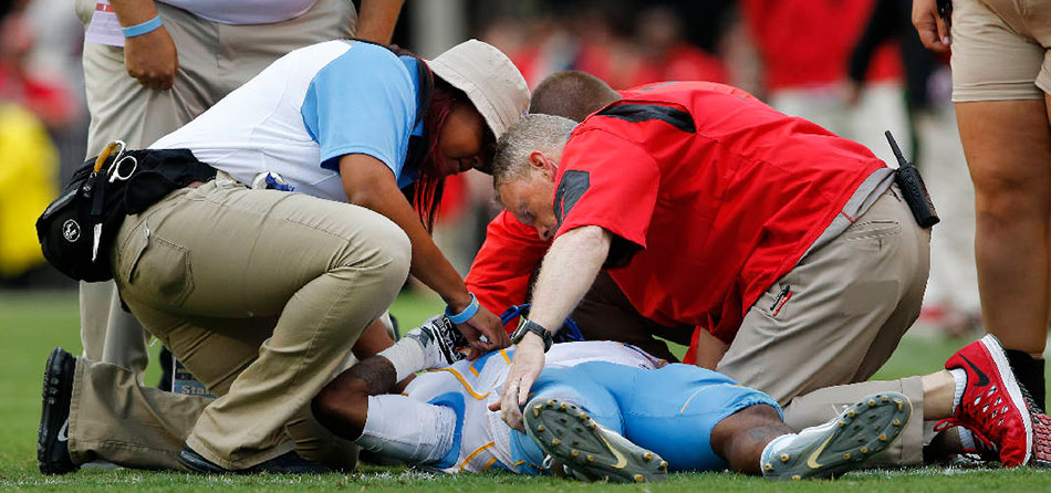 Medical crew attending to an injured football player